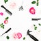 Hairdresser composition with spray, scissors, combs and pink flowers on white background. Beauty frame concept. Flat lay, top view