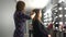 Hairdresser curling hair to brown hair girl in beauty salon