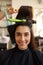 Hairdresser curls woman`s hair, closeup view