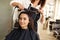 Hairdresser curls woman`s hair, hairdressing salon