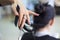 Hairdresser cutting client`s hair in beauty salon. Beauty concept