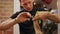 Hairdresser cutting the edges of female client hair with a thin comb in his hand