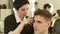 Hairdresser cutting hair with electric shaver in barbershop close up. Woman haircutter working with client and doing