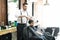 Hairdresser Cutting Hair Of Innocent Client At Barber Shop