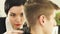 Hairdresser cutting male hair with electric shaver in beauty school. Woman haircutter making male haircut with hair
