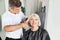 Hairdresser Cutting Senior Client\'s Hair