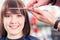 Hairdresser cutting woman bangs hair