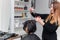 hairdresser doing hair styling to a woman in the salon, close-up