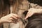 Hairdresser doing haircut closeup of work. Hairstylist does cutting hair tips of a female customer in a beauty salon