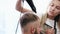 Hairdresser drying client\'s hair after haircut in salon