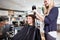 Hairdresser Drying Customer\'s Hair