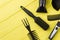 Hairdresser equipment on yellow wooden background.