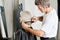 Hairdresser Examining Hair Length Of Client