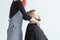 Hairdresser, hairstylist and barber shop concept - woman hairstylist cutting a bearded man