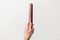 Hairdresser hand holding brown red hair comb