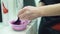 Hairdresser hands mixing hair color in plastic bowl, beauty salon occupation