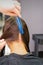 Hairdresser hands parting hair of woman