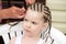 Hairdresser hands weaving a dreadlocks.