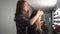 Hairdresser makes hairdress beautiful girl in a beauty salon