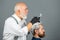 Hairdresser making of a color hair for a bearded hipster guy. Professional hairdresser coloring man hair. Process of a