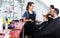 Hairdresser with male client in beauty salon