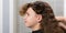 Hairdresser prepared hair of the child, with curly hair, for