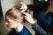 Hairdresser prepares for work with young woman.