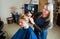 Hairdresser prepares for work with young woman.