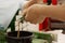 Hairdresser preparing bowl with peroxide for hair dyeing treatment, closeup