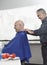 Hairdresser Removing Cape From Senior Man