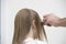 Hairdresser\'s Hand Combing Client\'s Wet Hair At Salon