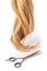 Hairdresser\'s scissors with strand of blond hair on white background