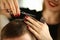 Hairdresser with Scissors Cutting Brown Male Hair