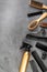 Hairdresser set in beauty salon. Combs, scissors, spray on grey desk top-down copy space