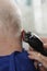 Hairdresser Shaving Man\'s Head With Hair Trimmer