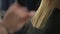 The hairdresser shears a woman with long blond hair. Haircut closeup