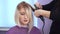 The hairdresser smoothes the hair of a beautiful young girl. hair straightening