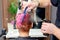 Hairdresser sprinkles water on hair