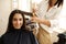 Hairdresser straightens woman`s hair, hairsalon