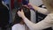 The hairdresser is styling the client\'s hair.