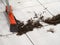 Hairdresser sweeping hair clippings on floor in barber shop.