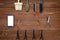 Hairdresser tools on wooden background. Top view on wooden table with scissors, comb, brush and hairclips with phone, free space.