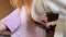 Hairdresser Trimming the Ends of a Blond Girls Hair. Mother doing daughter's haircut at home