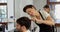 Hairdresser trimming her client hair