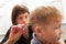 Hairdresser trimming a small boys hair