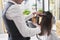 Hairdresser using comb and straightener