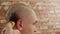 Hairdresser using trimmer for cutting long male hair. Man hair cutting to bald. Male haircut with electric shaver close
