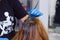 Hairdresser at work, young hairdresser dyes the client`s hair