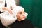 Hairdresser wraps client`s hair in towel after washing head