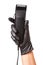Hairdressers hand in black rubber glove holds hair clipper